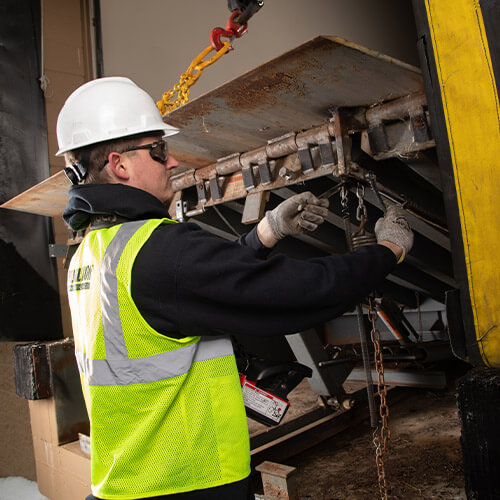 Reliable door and dock employee making a repair